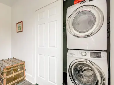 a washer and dryer in a room with a door at Stiles Historical Estate - 26th St in Denver