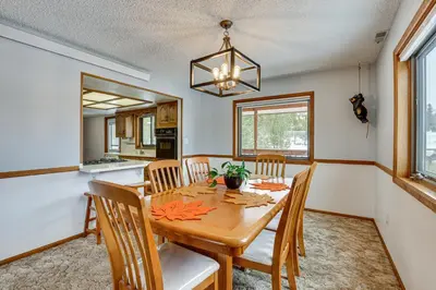 a dining room with a wooden table and chairs at Enjoy Deck and Mtn Views Grand Lake Retreat! in Grand Lake