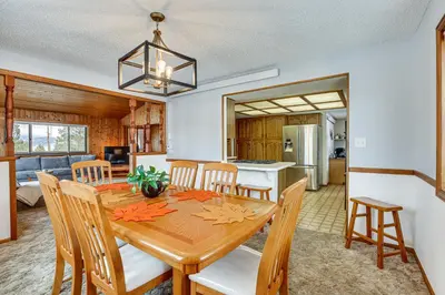 a dining room and kitchen with a wooden table and chairs at Enjoy Deck and Mtn Views Grand Lake Retreat! in Grand Lake
