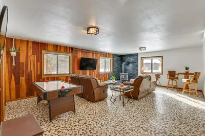 a living room with a ping pong table at Enjoy Deck and Mtn Views Grand Lake Retreat! in Grand Lake