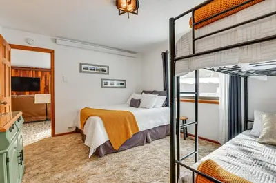 a bedroom with a bunk bed and a mirror at Enjoy Deck and Mtn Views Grand Lake Retreat! in Grand Lake