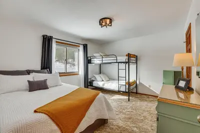 a bedroom with a bed and a bunk bed at Enjoy Deck and Mtn Views Grand Lake Retreat! in Grand Lake