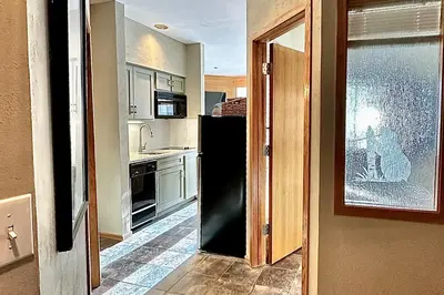 a kitchen with a black refrigerator and a window at River Run Sanctuary in Keystone