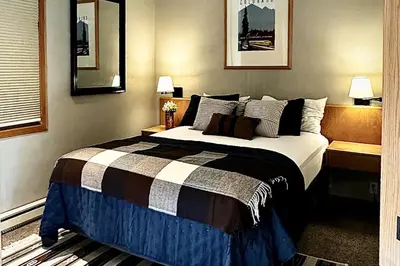 a bedroom with a large bed and two lamps at River Run Sanctuary in Keystone