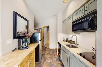 a kitchen with a sink and a refrigerator at River Run Sanctuary in Keystone