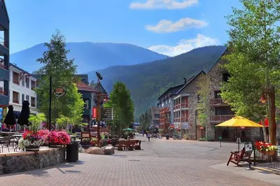 a street in a town with mountains in the background at River Run Sanctuary in Keystone