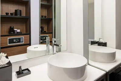 a bathroom with two sinks and a mirror at Aloft Denver Downtown in Denver