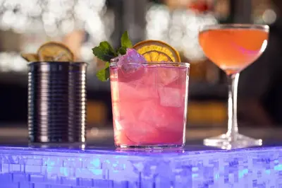 a drink sitting on a table with a glass at Aloft Denver Downtown in Denver