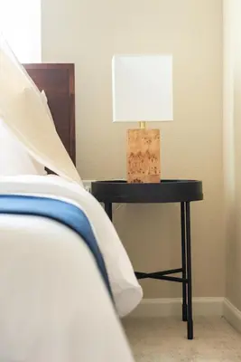 a table with a lamp on it next to a bed at Colorado Haven: 5bd - Pool & Foosball - 10min UCB in Superior
