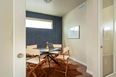 a dining room with a table with chairs and a laptop at Colorado Haven: 5bd - Pool & Foosball - 10min UCB in Superior