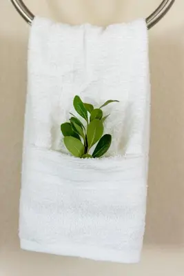 a white towel with a green plant in it at Colorado Haven: 5bd - Pool & Foosball - 10min UCB in Superior