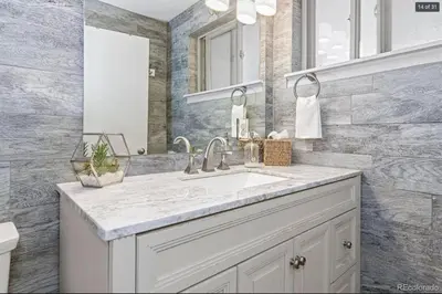 a bathroom with a sink and a mirror at Sunny Beach House of Olde Town Arvada in Arvada