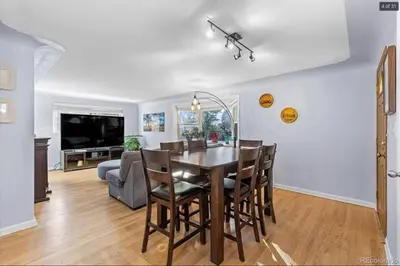 a dining room with a table and chairs and a couch at Sunny Beach House of Olde Town Arvada in Arvada