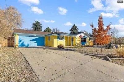 a yellow and blue house with a driveway at Sunny Beach House of Olde Town Arvada in Arvada