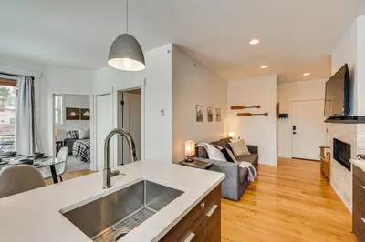 a kitchen and living room with a sink and a couch at 2 Mi to RMNP Mtn-View Grand Lake Loft! in Grand Lake