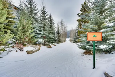 a sign in the snow next to some trees at 2 Mi to RMNP Mtn-View Grand Lake Loft! in Grand Lake