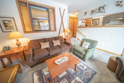 a living room with a couch and two chairs at Montezuma 1763 by SummitCove Lodging in Keystone