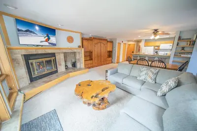 a living room with a couch and a fireplace at Liftside 201 by SummitCove Lodging in Keystone