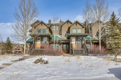 a large house with snow in front of it at Ski-InandSki-Out Granby Ranch Condo with Pool Access in Granby