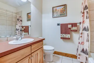 a bathroom with a sink and a toilet and a shower at Ski-InandSki-Out Granby Ranch Condo with Pool Access in Granby