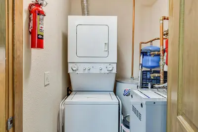 a washer and dryer in a small laundry room at Ski-InandSki-Out Granby Ranch Condo with Pool Access in Granby