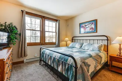 a bedroom with a bed and a tv at Ski-InandSki-Out Granby Ranch Condo with Pool Access in Granby