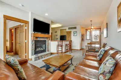 a living room with a couch and a fireplace at Ski-InandSki-Out Granby Ranch Condo with Pool Access in Granby