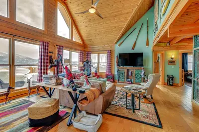 a living room with a couch and a table at Private Hot Tub Mtn-View Grand Lake Cabin! in Grand Lake