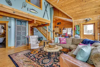 a living room with a couch and a table at Private Hot Tub Mtn-View Grand Lake Cabin! in Grand Lake