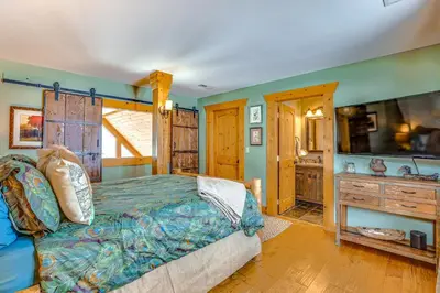 a bedroom with a bed and a tv in a room at Private Hot Tub Mtn-View Grand Lake Cabin! in Grand Lake