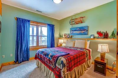 a bedroom with a bed and a window at Private Hot Tub Mtn-View Grand Lake Cabin! in Grand Lake