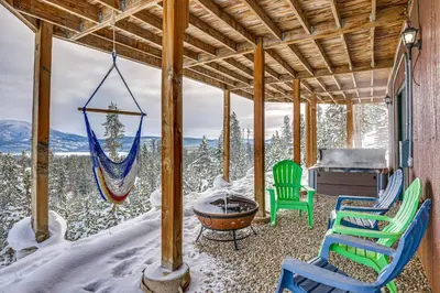 a porch with chairs and a hammock and a piano at Private Hot Tub Mtn-View Grand Lake Cabin! in Grand Lake