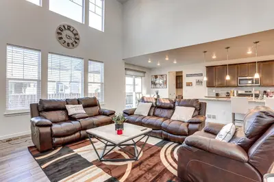 a living room with leather furniture and a table at 16 Mi to Denver Spacious Commerce City Home! in Commerce City