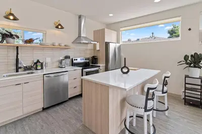 a kitchen with a counter and two stools at Beautiful Denver Carriage House in Denver
