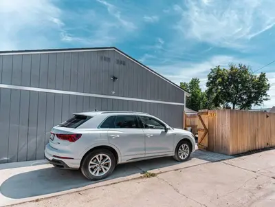 a white car parked in front of a building at Beautiful Denver Carriage House in Denver