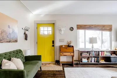 a living room with a green couch and a yellow door at Unique Denver Designer Home 4 Bed 4 Bath in Denver