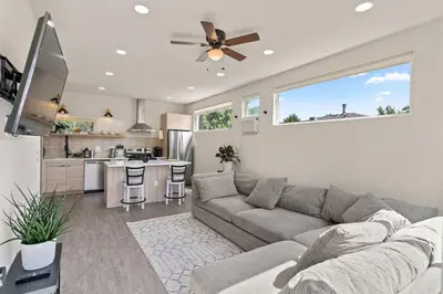 a living room with a couch and a kitchen at Unique Denver Designer Home 4 Bed 4 Bath in Denver