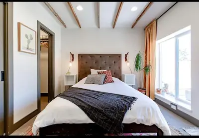a bedroom with a large bed and a large window at Unique Denver Designer Home 4 Bed 4 Bath in Denver
