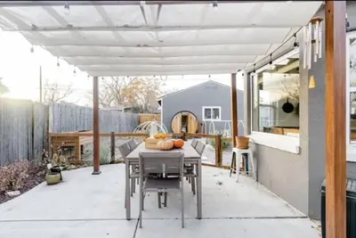 a patio with a table and a white pergola at Unique Denver Designer Home 4 Bed 4 Bath in Denver