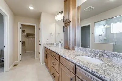 a bathroom with a sink and a mirror at 17 Mi to Downtown Denver Modern Aurora Home! in Aurora