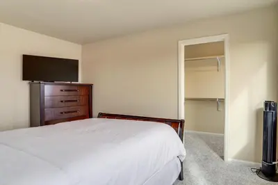 a bedroom with a bed and a flat screen tv at 17 Mi to Downtown Denver Modern Aurora Home! in Aurora