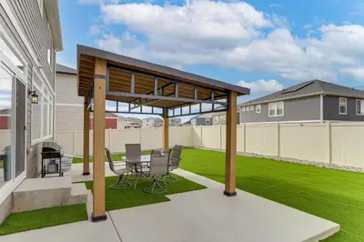 a pergola on a patio with a lawn at 17 Mi to Downtown Denver Modern Aurora Home! in Aurora