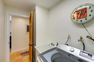 a washing machine in a room with a clock on the wall at Spacious Black Hawk Home with Deck and Mountain Views! in Black Hawk