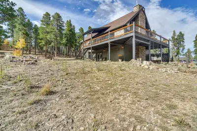 a large house on a hill with a yard at Spacious Black Hawk Home with Deck and Mountain Views! in Black Hawk