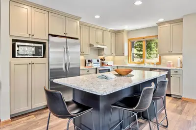 a kitchen with a large island with bar stools at Aspen Spirit Vacation Home at Windcliff home in Estes Park