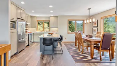 a kitchen and dining room with a table and chairs at Aspen Spirit Vacation Home at Windcliff home in Estes Park