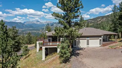 a house with a view of a mountain at Aspen Spirit Vacation Home at Windcliff home in Estes Park
