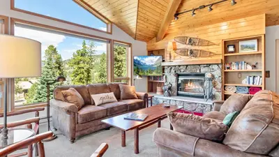 a living room with a couch and a fireplace at Aspen Spirit Vacation Home at Windcliff home in Estes Park