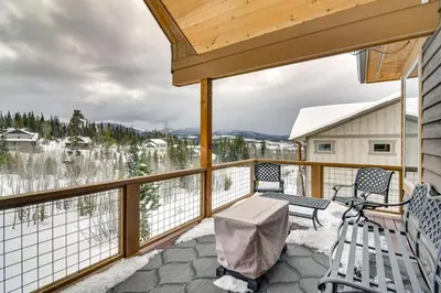 a deck with two chairs and a table on a snow coveredfficiencyfficiencyfficiencyfficiency at Family Home with Hot Tub 6 Mi to Winter Park Resort in Fraser