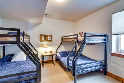 a bedroom with two bunk beds and a window at Family Home with Hot Tub 6 Mi to Winter Park Resort in Fraser